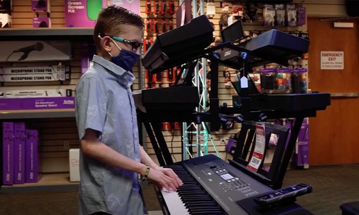 Eleven-year-old Colton McCurdy plays the piano